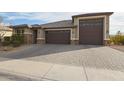 Well-maintained single-Gathering home with desert landscaping and a three-car garage at 7735 W Agora Ln, Phoenix, AZ 85043