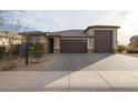 Inviting single-Gathering home featuring a three-car garage and manicured landscaping at 7735 W Agora Ln, Phoenix, AZ 85043