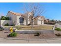 Charming home features a low-maintenance yard, tile roof, and a two-car garage at 9826 E Irwin Cir, Mesa, AZ 85209