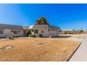 Charming home featuring manicured front yard and decorative details at 10419 W Loma Blanca Dr, Sun City, AZ 85351