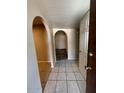 View of the entryway featuring a tiled floor and an arched hallway at 113 W Bluefield Ave, Phoenix, AZ 85023