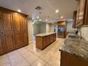 Spacious kitchen with granite countertops, stainless steel appliances, ample cabinet space, and tiled flooring at 113 W Bluefield Ave, Phoenix, AZ 85023