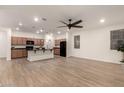 Open-concept living space showcasing wood flooring, a ceiling fan, and seamless flow into the kitchen at 11674 E Yeager Cyn, Gold Canyon, AZ 85118