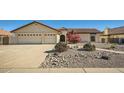 Inviting single-story home with a two-car garage and desert landscaping in front at 13009 S 42Nd Pl, Phoenix, AZ 85044