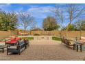 Spacious backyard featuring a paver patio, fire pit, outdoor seating, and a hammock for ultimate relaxation and entertainment at 2514 E Espada Trl, Casa Grande, AZ 85194
