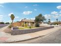 Well-maintained single-story home with desert landscaping, block wall and driveway at 3802 N 73Rd Ave, Phoenix, AZ 85033