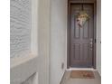 Inviting front door with a decorative wreath and a 'hello' doormat at 40520 W Haley Dr, Maricopa, AZ 85138