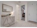 Hallway with view to home office, and a decorative table with mirror at 40520 W Haley Dr, Maricopa, AZ 85138