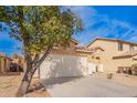 Exterior elevation of a single-story home in a desert landscape with a tile roof at 44792 W Paitilla Ln, Maricopa, AZ 85139