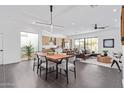 Spacious dining area flowing into the living room, featuring modern lighting and sleek tile flooring at 4514 N 8Th Pl, Phoenix, AZ 85014