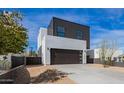 Beautiful modern home boasting a sleek garage door and desert-style landscaping under a clear, sunny sky at 4514 N 8Th Pl, Phoenix, AZ 85014