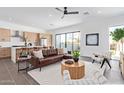 Bright living room with an open layout, flowing into the kitchen, with a ceiling fan and contemporary furnishings at 4514 N 8Th Pl, Phoenix, AZ 85014