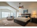 Relaxing main bedroom with ceiling fan, chaise lounge, and large windows at 7415 W Via De Luna Dr, Glendale, AZ 85310