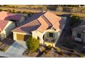 Aerial view of a single-Gathering house in a residential neighborhood, featuring a tile roof at 8071 W Valor Way, Florence, AZ 85132