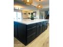 Expansive kitchen island with marble countertop and dark cabinetry adding functionality and style at 8740 E Mulberry St, Scottsdale, AZ 85251