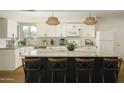 Kitchen showcasing white cabinetry, stainless steel appliances, and a dark-colored kitchen island at 8740 E Mulberry St, Scottsdale, AZ 85251
