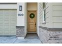 Inviting front entrance with a wreath-adorned door and stone accents at 909 E Desert Ln, Phoenix, AZ 85042