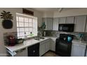 Well-lit kitchen features updated appliances, gray cabinets and a stylish backsplash for a modern look at 921 W University Dr # 1101, Mesa, AZ 85201