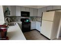 Bright kitchen with updated appliances, gray cabinets and tiled flooring at 921 W University Dr # 1101, Mesa, AZ 85201