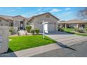 Lovely home with desert landscaping, a spacious driveway, and a two-car garage at 9705 E Carefree Way, Chandler, AZ 85248