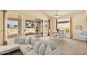 Bright living room with large sliding glass doors and view of the backyard and patio at 10914 E Navajo Dr, Sun Lakes, AZ 85248