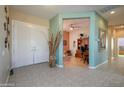 Inviting foyer with tiled flooring, a decorative vase, and an open view into the office at 16935 W Desert Blossom Way, Surprise, AZ 85387