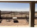 Relaxing back patio with brick pavers and views of the backyard with a black fence at 20407 W Calle Encorvada --, Buckeye, AZ 85396