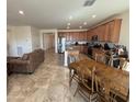 Spacious open-concept kitchen with an island, granite countertops, and stainless steel appliances at 20407 W Calle Encorvada --, Buckeye, AZ 85396