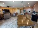 Spacious living room and kitchen combo with tile flooring, stainless steel appliances, and a dining area at 20407 W Calle Encorvada --, Buckeye, AZ 85396
