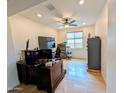 Bright office space featuring wood floors, a ceiling fan, and a large window for natural light at 20407 W Calle Encorvada --, Buckeye, AZ 85396