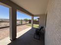 Covered patio with brick pavers, offering a shaded retreat and views of the backyard and beyond at 20407 W Calle Encorvada --, Buckeye, AZ 85396