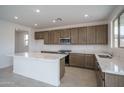 Modern kitchen with sleek countertops, stainless steel appliances, and ample cabinet space at 21291 W Edgemont Ave, Buckeye, AZ 85396