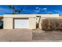 Detached garage with white door provides private parking and additional storage space for the residence at 2157 N Recker Rd, Mesa, AZ 85215