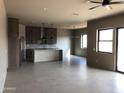 Open floor plan with modern kitchen, recessed lighting, ceiling fan and large windows at 29022 N 166Th Ave, Surprise, AZ 85387