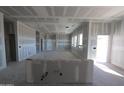 Unfinished living room featuring large windows, an open layout, and light-colored drywall at 29022 N 166Th Ave, Surprise, AZ 85387