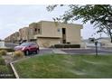 Modern townhomes with well-maintained landscaping, green grass, and a red car parked nearby at 3113 E Danbury Rd # 5, Phoenix, AZ 85032