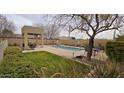 Community pool and lounging area with seating and manicured green spaces at 3113 E Danbury Rd # 5, Phoenix, AZ 85032