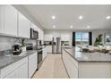 Bright kitchen with stainless steel appliances, large island, and plenty of storage at 36041 W San Ildefanso Ave, Maricopa, AZ 85138