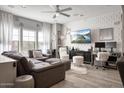 Well-lit living room with a large sectional, television, and decorative accents at 3935 E Rough Rider Rd # 1267, Phoenix, AZ 85050