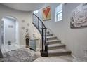 Curved staircase with carpeted steps and a decorative heart painting on the wall at 3935 E Rough Rider Rd # 1267, Phoenix, AZ 85050
