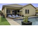 Beautiful outdoor pool and patio area featuring lounge chairs and a covered patio at 41262 W Almira Dr, Maricopa, AZ 85138