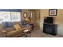 Cozy living room featuring comfortable seating and a fireplace at 44 S Hawes Rd # C13, Mesa, AZ 85208