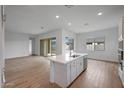 Bright kitchen with a large island and stainless steel dishwasher, open to the living area at 44729 N 44Th Dr, Phoenix, AZ 85087