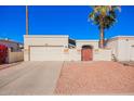 Charming single-story home features a two-car garage, private gate, and desert landscaping at 4722 W Escuda Dr, Glendale, AZ 85308