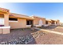 Charming exterior view of desert homes with red tile roofs, stucco exteriors, and rock landscaping at 501 W Hononegh Dr # 2, Phoenix, AZ 85027