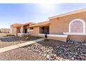 A pleasant street view of homes with stucco exteriors and desert landscaping at 501 W Hononegh Dr # 2, Phoenix, AZ 85027