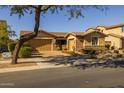 Inviting single-story home featuring a brick driveway, two-car garage, and landscaped front yard at 5054 S Advant Ter, Mesa, AZ 85212