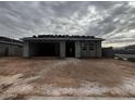 New construction of single-story home with an open garage and roof being installed at 5615 W Summerside Rd, Laveen, AZ 85339