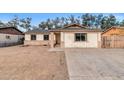 A single-story home featuring a quaint facade and a concrete driveway on a sunny day at 6132 W Windsor Ave, Phoenix, AZ 85033