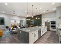 Open-concept kitchen featuring granite countertops, stainless steel appliances, and pendant lighting at 7340 E Conquistadores Dr, Scottsdale, AZ 85255